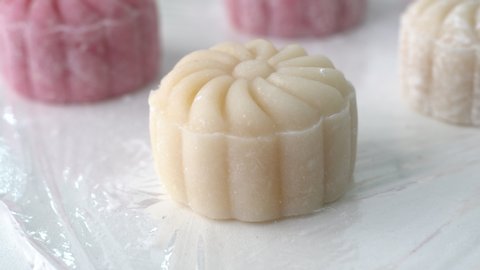 Making colorful snow skin moon cake, recipe of sweet snowy mooncake, traditional savory dessert for Mid-Autumn Festival, close up, lifestyle.