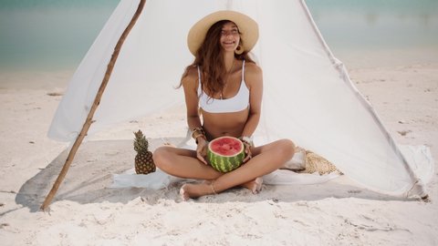 Woman on the Tropical Beach Eating Watermelon