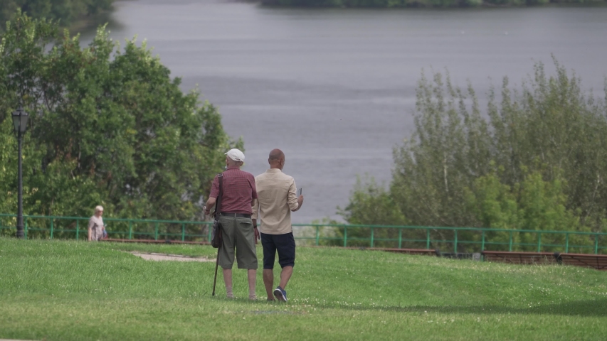 People old friends walking going down to the river