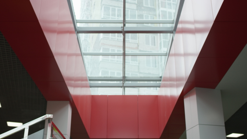 A bottom view slow motion close up of a blonde female executive happily walking in a hallway of an office building being ready for an upcoming day