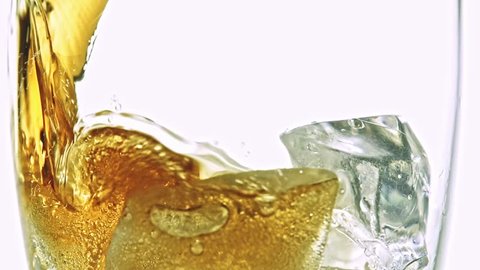 Cola with ice. Pouring Cola with Ice and bubbles in a glass. Slow motion 240 fps. Close up food and beverage background. Stock full HD video footage 1920x1080p.