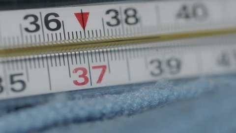 Mercury thermometer close-up rotating. high body temperature