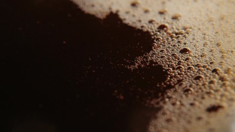 Macro photography of coffee, dropping a drop of coffee into a liquid.