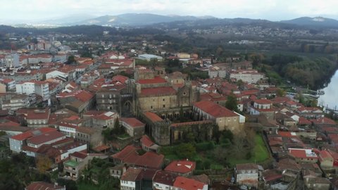 Flying above a beautiful small town full of gable roof houses at the valley of Miño river. This is located in Pontevedra district, Galicia - Spain.