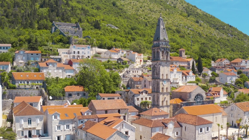 Perast, Montenegro. Aerial top view of the cityscape and St. Nicholas Church  | Shutterstock HD Video #1057828642