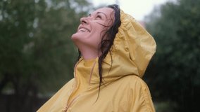 Happy woman smiling in the rain. The concept of love, nature, happiness, freedom.