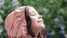 Close up portrait of girl looking at rain in nature with wet hair
