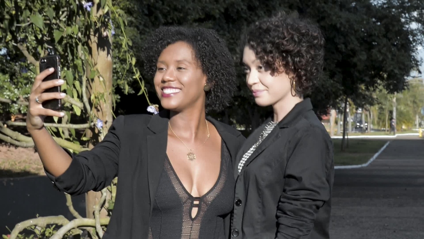 Two women making selfies smiling outdoors