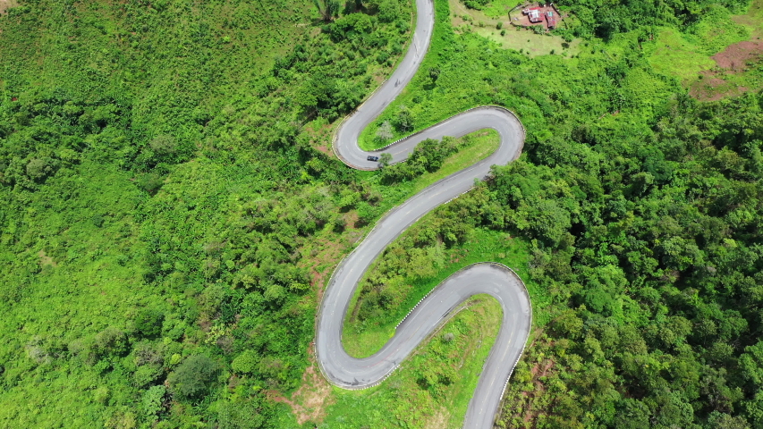 Aerial view of Beautiful sky road over top of mountains with green jungle in Nan province, Thailand. | Shutterstock HD Video #1057849423