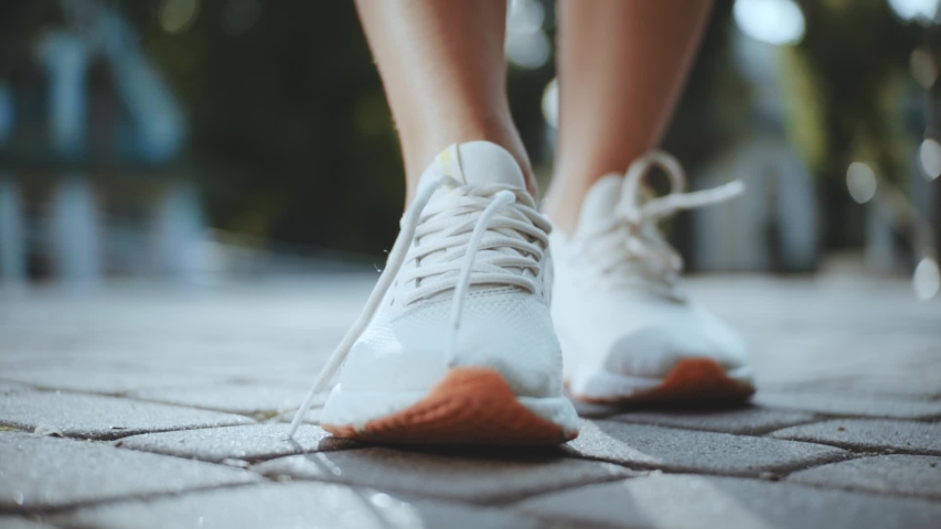 At sunlight hands woman tying shoe laces and running athlete jogging sport fitness foot speed leg activity health footwear female exercise healthy slow motion Royalty-Free Stock Footage #1057859506