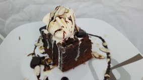 Preparing a Brownie with ice cream on the dish