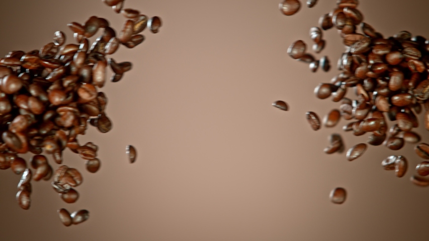 Super Slow Motion Shot of Crashing Coffee Beans on Brown Gradient Background at 1000fps. Royalty-Free Stock Footage #1057861165