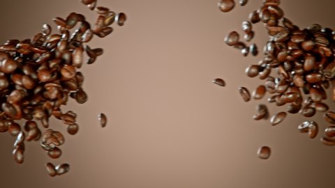 Super Slow Motion Shot of Crashing Coffee Beans on Brown Gradient Background at 1000fps.