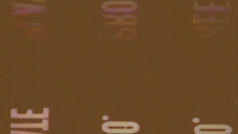 Writing, Old Film Leader with dust and scratches, Vintage Damaged Film Strip, Brown Background
