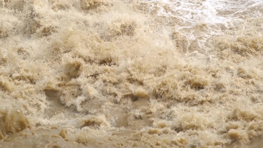 Dirty water of muddy river in flooding period during heavy rains in spring. Royalty-Free Stock Footage #1057871188