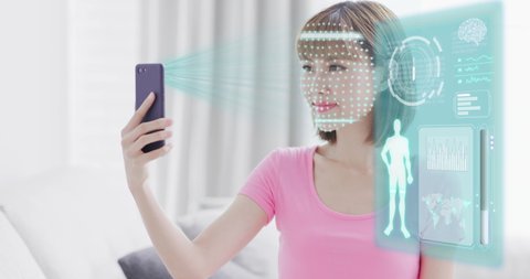 young woman use smart phone unlocking with biometric facial identification indoor