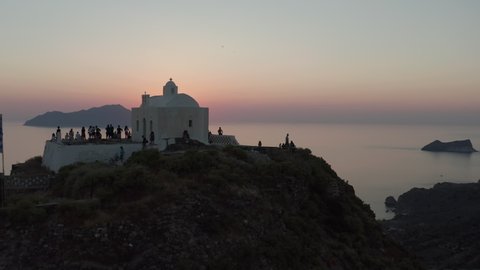 People Tourists Enjoying the Sunset from Church Viewing Point over Island in Greece