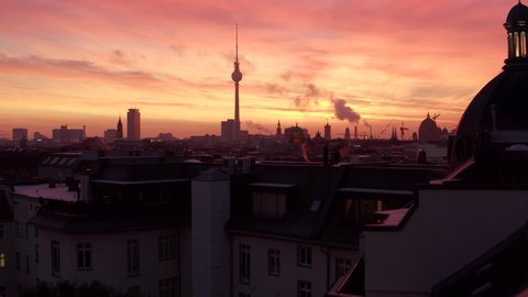 Low flight over Berlin Rooftops with Fire Red Sunrise Sunset