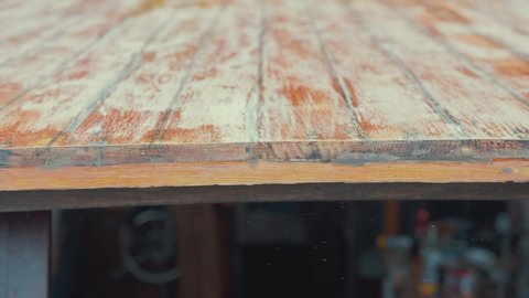 Hand sanding edge of wooden boat wheelhouse cabin planks CLOSE UP
