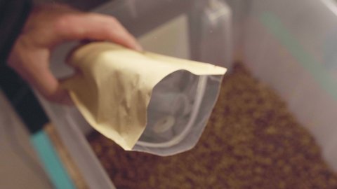 Coffee packaging A man packs coffee in a bag! High quality 4k footage