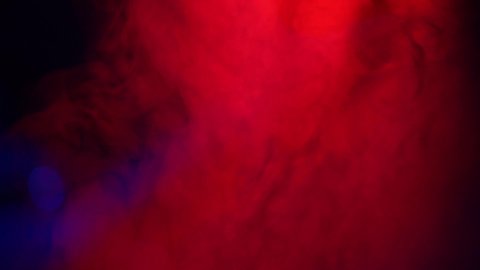 Soft Red Fog in Slow Motion on Dark Backdrop. Realistic Atmospheric Red Smoke on Black Background. Red Fume Slowly Floating Rises Up. Abstract Haze Cloud. Smoke Stream Effect