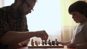 Portrait of Smart Little Boy and Father Playing Chess. Child Playing Chess With Friend at Home, Development of Logical Thinking for Children. Intellect, Intelligence. Development Logical Thinking.  - Powered by Shutterstock - Get 15% off with code: PIKWIZARD15