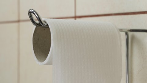 Roll of toilet paper in the bathroom. Run out of toilet paper in close up