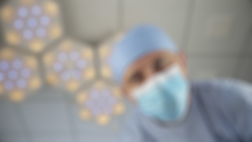 Patient wakes up after a coma. Doctor checks the reaction of the pupils of the eyes with bright light. First-person view, defocus Royalty-Free Stock Footage #1057890430