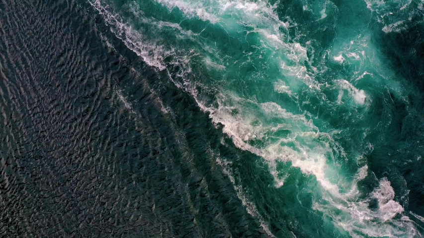 Waves of water of the river and the sea meet each other during high tide and low tide. Whirlpools of the maelstrom of Saltstraumen, Nordland, Norway | Shutterstock HD Video #1057895884