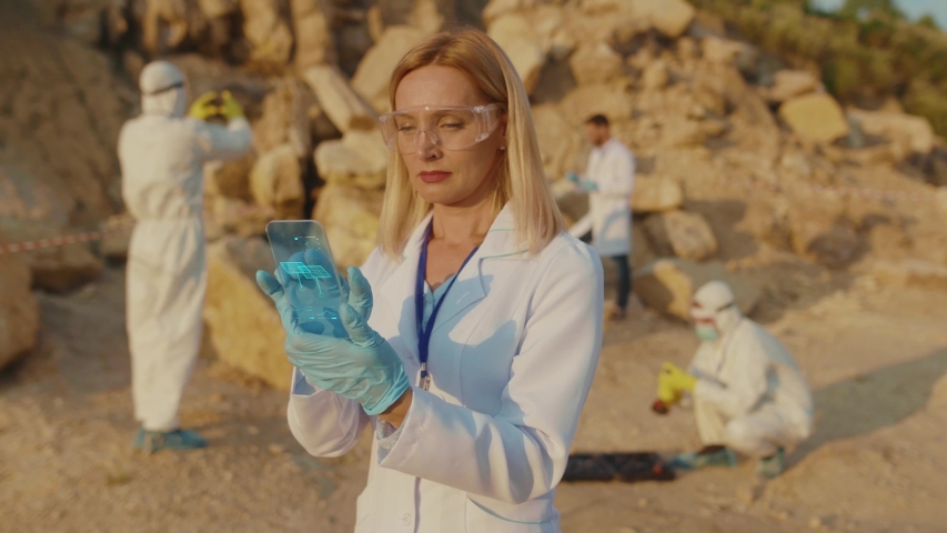 Nice Woman Ecology Expert Using Smartphone Browsing Holographic Models of Solar Panels. Ecological Construction of Alternative Energy Solar Station. Animation. Future Concept.