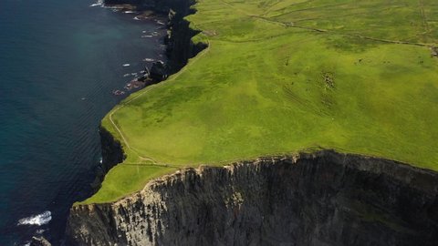 Green Cliffs of Moher tourist attraction, Ireland west coast, aerial reveal