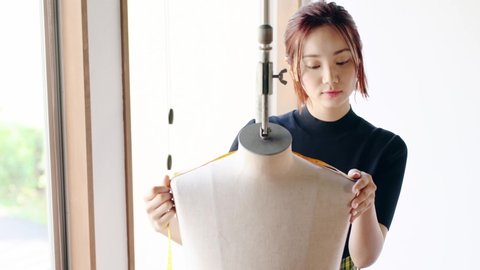Young asian woman making clothes. Fashion designer. Tailor made.