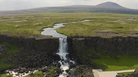 Aerial view of the Oxarafoss waterfall in Iceland. Oxarafoss also called Oxararfoss is located in the Thingvellir National Park on the Oxara River. 4K UHD video.