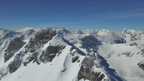 4k winter footage, flying along mountain range with snow and wonderful winter panorama in background
