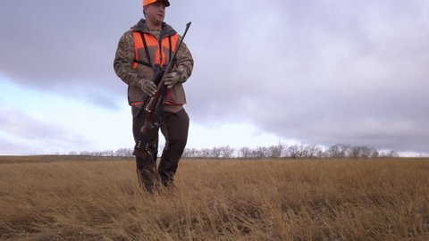 Hunter calls his loyal retriever gun dog to his side, Saskatchewan Canada