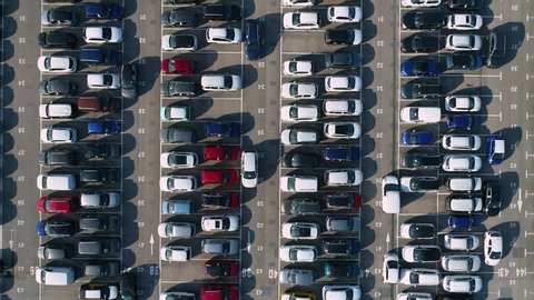 Top down view. Aerial footage over organized parking lot for second hand (used) cars. Automotive sector concept.