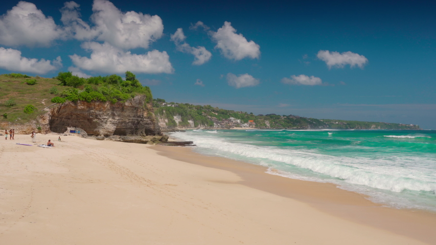 Dreamland beach in Bali, Indonesia is a picturesque beach located on the Bukit peninsula about half an hour's drive from Kuta and is perfect for surfing and beach holidays. 4K Royalty-Free Stock Footage #1057913857
