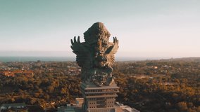 Bali's Most Iconic Landmark Hindu God Garuda Wisnu Kencana statue also GWK statue is a 122-meter tall statue located in Garuda Wisnu Kencana Cultural Park, Bali, Indonesia. 4k Aerial view
