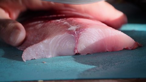 4k-24. close-up slicing marlin steak with a knife. High quality 4k footage