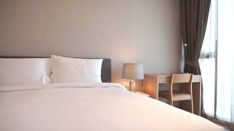 Comfortable Kingsize Bed in Master Bedroom of Luxury Hotel Resort, Full Frame. Pan Right