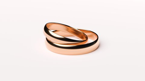 Wedding Golden Rings lie on white rotating background surface viewed from all sides with light copy space - Seamless Full HD loop footage