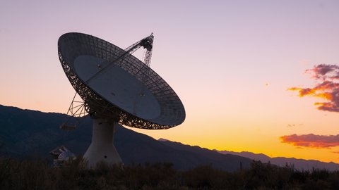 Time lapse of sun setting behind large radio observatory in Eastern Sierra, California
