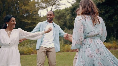 Couples enjoying dancing together outdoors. Multi ethnic group of friends hanging out dancing at park on a summer weekend.
 Stockvideo