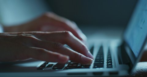 Close up shot of an young business woman's hands busy working on laptop or computer keyboard for send emails and surf on a web browser late hour at night.