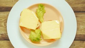 Cheese sandwiches on a wooden board rotate in a circle. - Powered by Shutterstock - Get 15% off with code: PIKWIZARD15