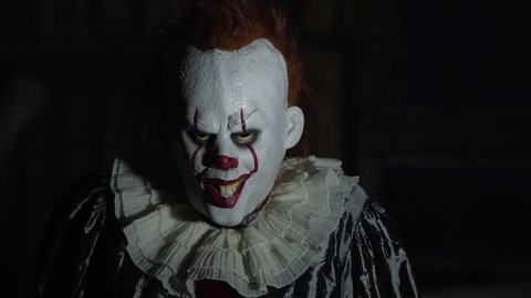Evil Clown Make Up, Scary Halloween Horror Scene, Frightening with Balloon.