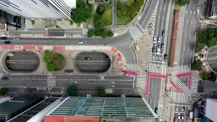 Top Down View of Intersection of famous avenues in Brazil. Paulista  and Consolacao Avenues. Transportation Scene. Aerial View of Traffic and Pedestrian on Crosswalk. Aerial Landscape of Sao Paulo Royalty-Free Stock Footage #1057933528