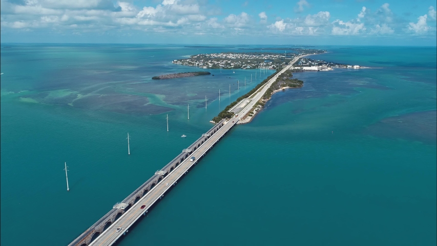 Key West: 7 Mile Bridge, Florida Keys, United States. Aerial view of bridge road and Islands near Key West, Florida Keys. Travel highway road. Freeway road. Viaductscene. Highway bridge coastal road. Royalty-Free Stock Footage #1057933540