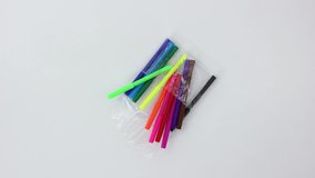 Office supplies multicolored felt-tip pens on white wooden spinning table background.