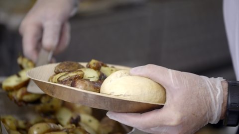 Close up of a plate of fried potatoes and a bred that a man puts more on it. Filmed in slowmotion and 1080p.
